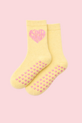 Yellow socks with pink heart design and text on a white background